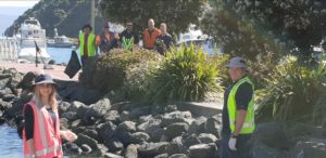 NZKS team standing on the waterfront during their beach clean up